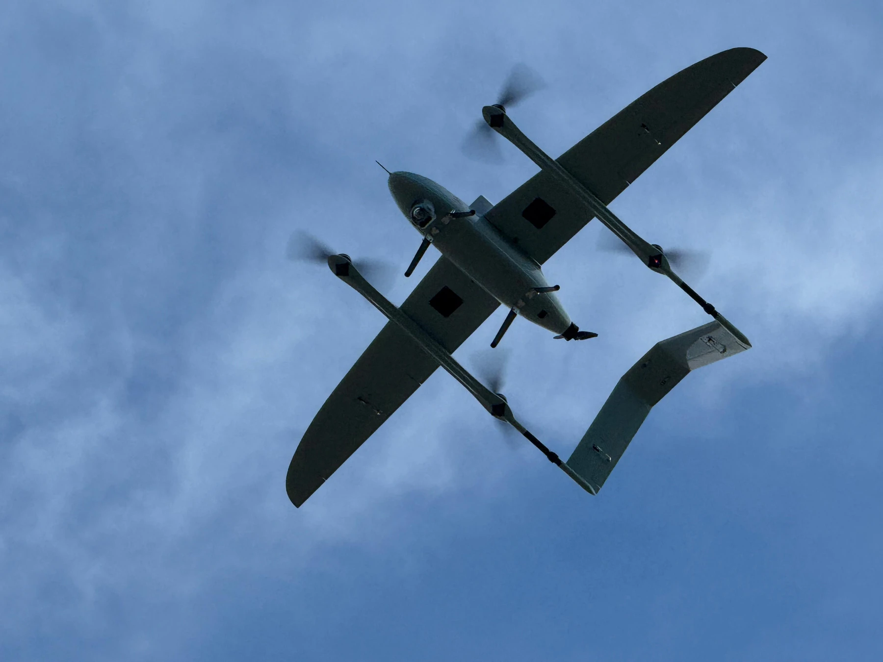 Close view of the ORKID 260 in flight showing its underside and sensor payload